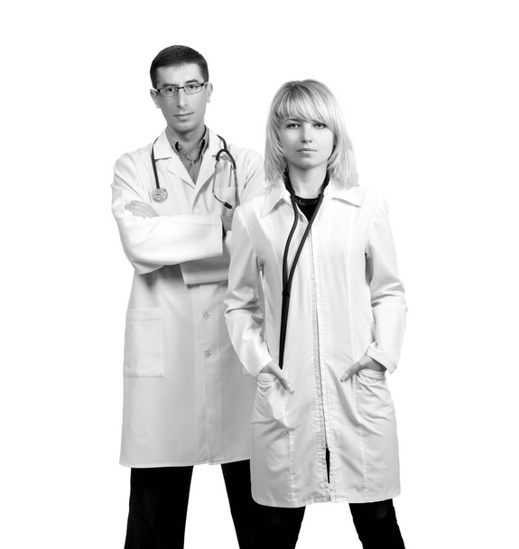 Man and woman in white coats of doctors with stethoscopes on a white background in isolation - Fotografie, Obrázek