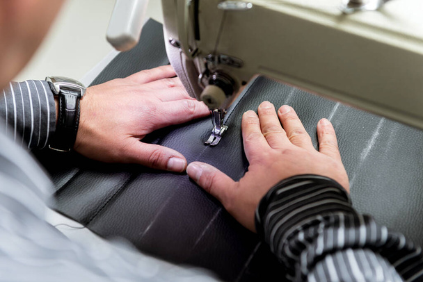 Designer tailor sew seat covers. Man use sewing machine for his work. - Фото, зображення