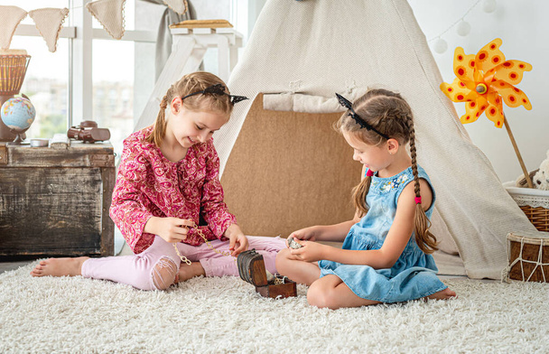 Little girls playing with treasure box - Valokuva, kuva