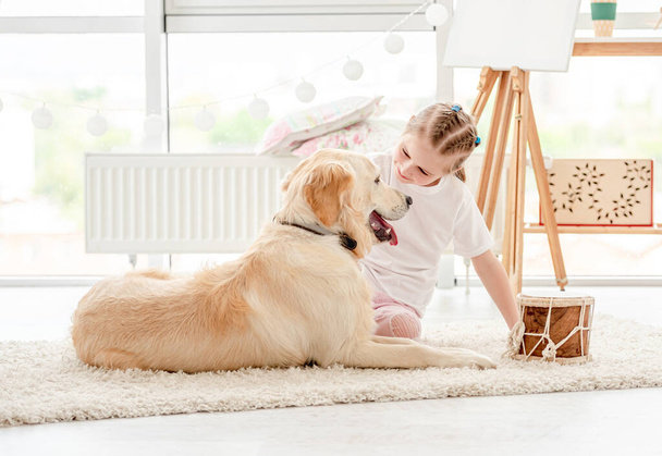 Little girl playing music with dog - Photo, Image
