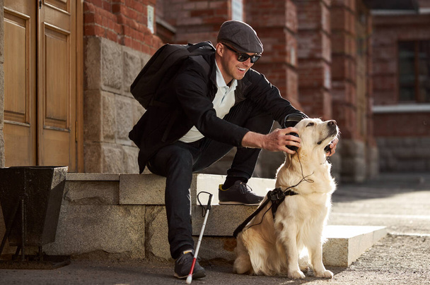 blind man with dog, caring favorite pet - Foto, afbeelding