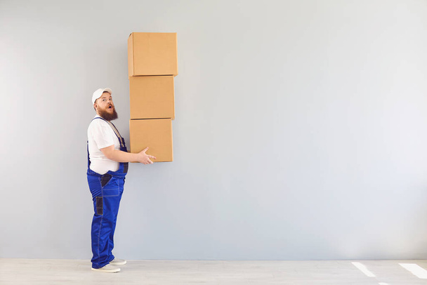 Content delivery man with pile of boxes - Fotó, kép