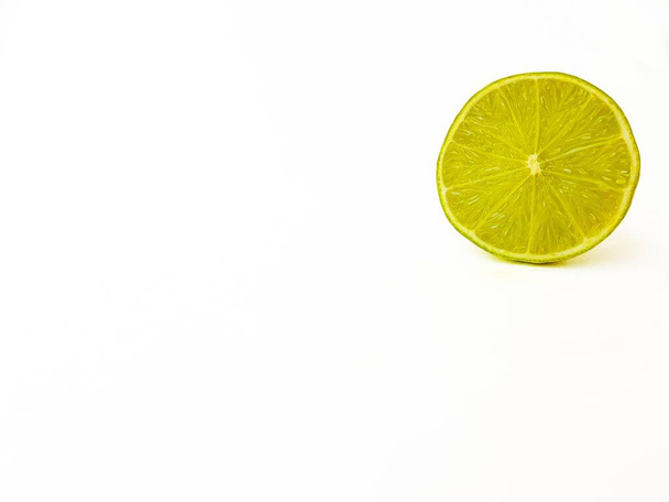 Bright juicy green lime on a white background cut in half. - Foto, imagen