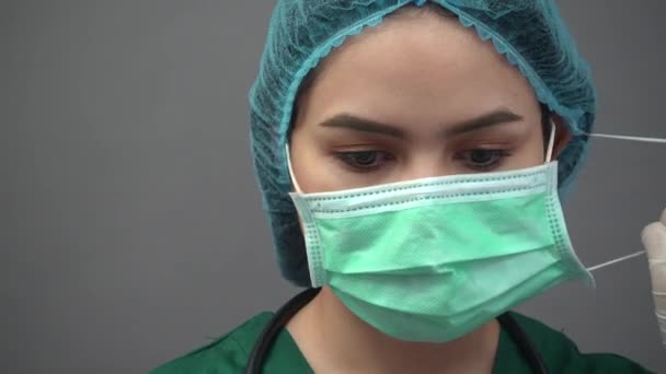 Portrait of young woman doctor in uniform green scrubs feeling down and very tired with pandemic covid-19 - Imágenes, Vídeo