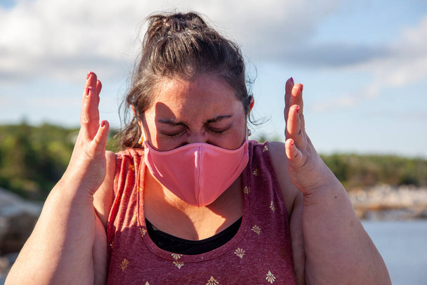 donna odia indossare la sua maschera viso pandemica sta urlando o piangendo di rabbia  - Foto, immagini