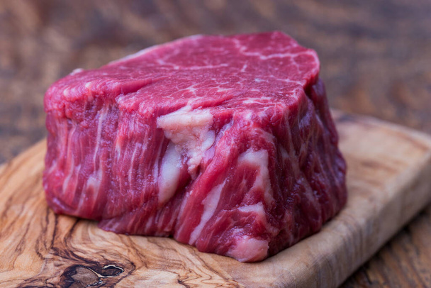 raw steak on dark wood - Φωτογραφία, εικόνα