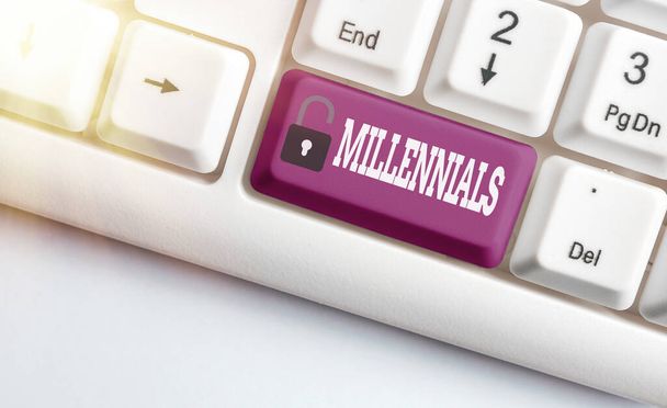 Word writing text Millennials. Business concept for an individual reaching young adulthood in the early 21st century Different colored keyboard key with accessories arranged on empty copy space. - Photo, Image