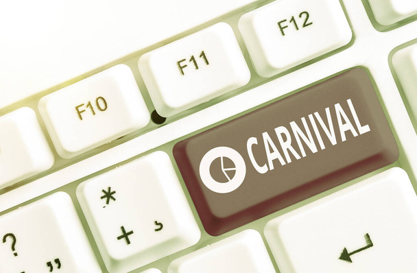 Text sign showing Carnival. Conceptual photo traveling enterprise offering amusements, exhibitions, etc. Different colored keyboard key with accessories arranged on empty copy space. - Photo, Image