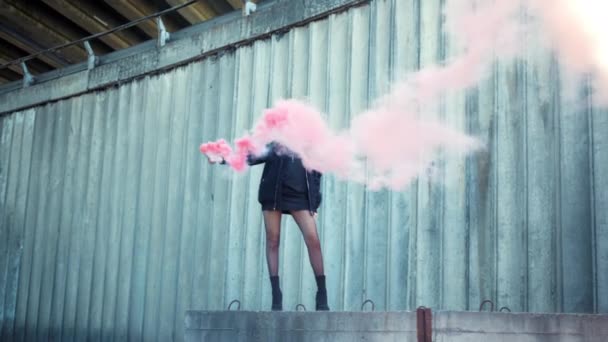 Girl standing on street with smoke bomb in hand. Woman holding smoke grenade - Footage, Video