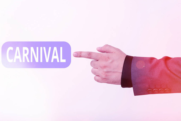 Text sign showing Carnival. Conceptual photo traveling enterprise offering amusements, exhibitions, etc. Model with pointing hand finger symbolizing navigation progress growth. - Photo, Image