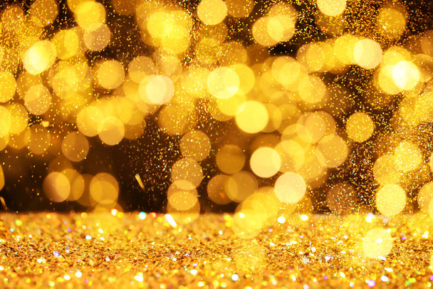 Luxury golden glitters on dark background. Bokeh effect  - Foto, immagini