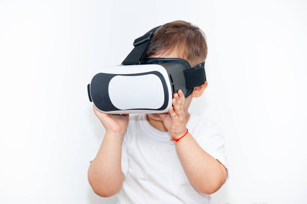 little boy with virtual reality glasses on a white background - Фото, зображення