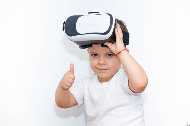 little boy with virtual reality glasses on a white background - Foto, Imagen