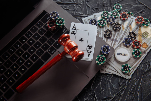 Δικαστής ξύλινο σφυρί, χαρτονομίσματα και κάρτες παιχνιδιού στο πληκτρολόγιο του υπολογιστή, νομικοί κανόνες για την έννοια των τυχερών παιχνιδιών σε απευθείας σύνδεση - Φωτογραφία, εικόνα