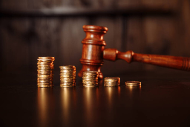 TAX payment concept. Stack of coins with wooden judge gavel. - Zdjęcie, obraz