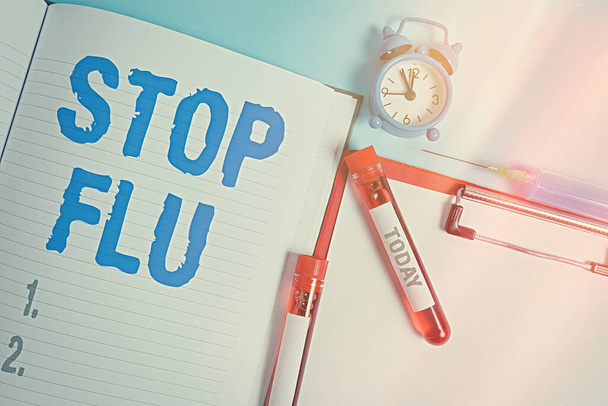 Writing note showing Stop Flu. Business photo showcasing put an end of the viral infection of your lungs and airways Blood sample vial medical accessories ready for examination. - Photo, Image