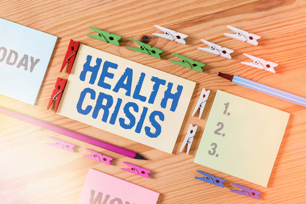 Word writing text Health Crisis. Business concept for fitness problem that affects in more geographic areas Colored clothespin papers empty reminder wooden floor background office. - Photo, Image