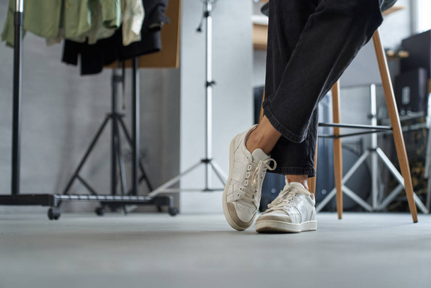 Woman in sneakers spending time in showroom - Photo, image