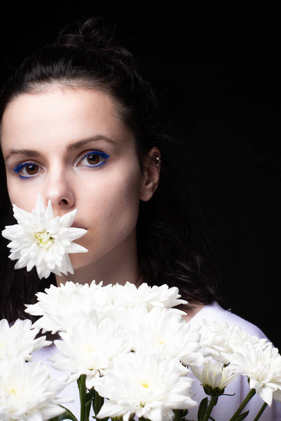 beautiful woman with white flowers on a dark background - Zdjęcie, obraz