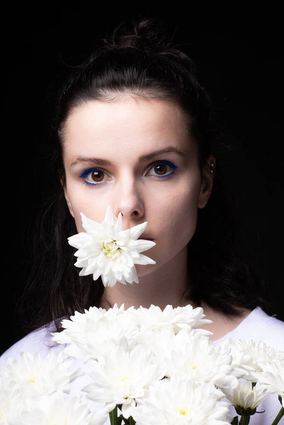 beautiful woman with white flowers on a dark background - Photo, image