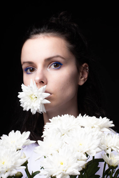 woman with a bouquet of flowers, black background - Photo, image