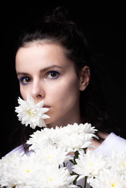 woman with flowers, black background - Фото, изображение