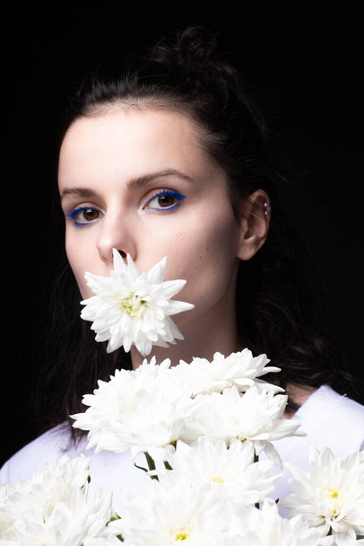girl with flowers, black background - Photo, image