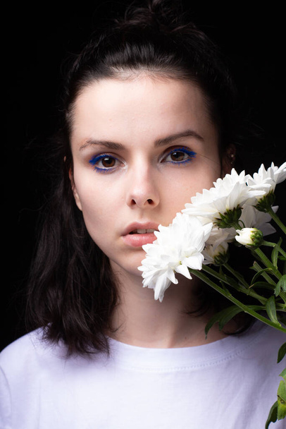 woman of model appearance, portrait with white flowers on black studio background - Fotografie, Obrázek