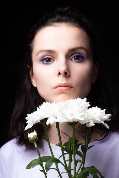 woman of model appearance, portrait with white flowers on black studio background - Фото, зображення