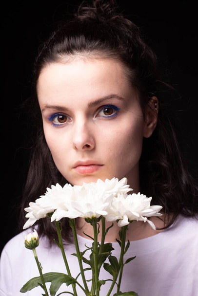 woman of model appearance, portrait with white flowers on black studio background - Photo, Image