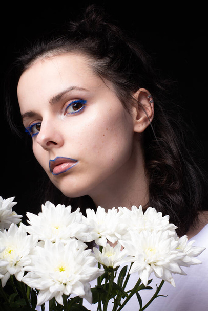 woman of model appearance, portrait with white flowers on black studio background - Φωτογραφία, εικόνα