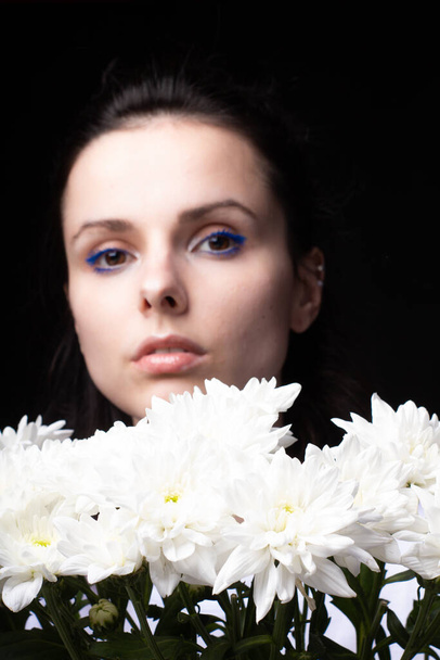 beautiful woman with white flowers on a dark background - Photo, image