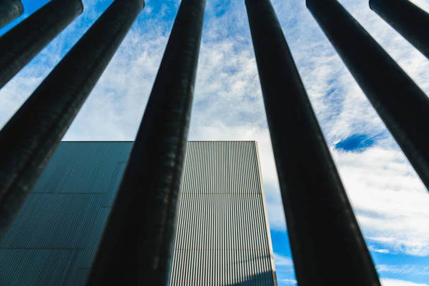 Vertical steel bars, a fence that separates and protects buildings from the street. - Photo, Image