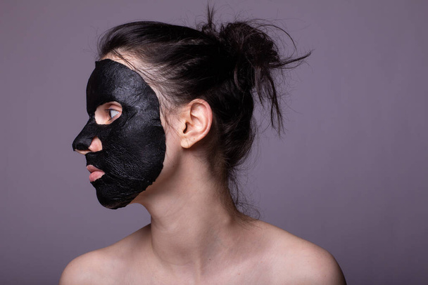 woman in black cloth mask on face, cosmetic skin care - Photo, Image