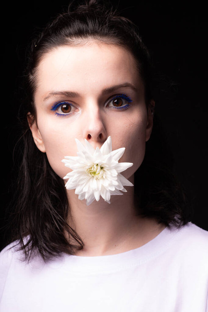 woman with chrysanthemums on a black background - 写真・画像
