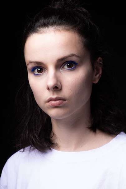 beautiful girl with blue makeup in white clothes on a dark background - Φωτογραφία, εικόνα
