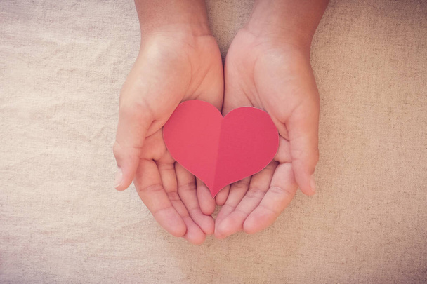 hands and red heart, health insurance, donation and charity concept - Фото, зображення
