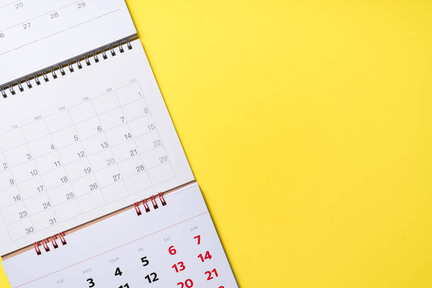 close up of calendar on the yellow table background, planning for business meeting or travel planning concept - Fotoğraf, Görsel