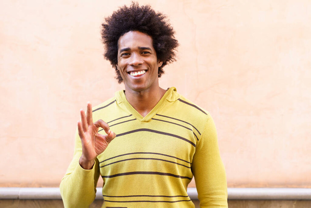 Fekete férfi afro haj üzembe egy vicces kifejezés - Fotó, kép