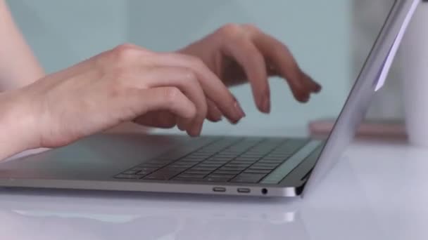 Woman's hands write at desktop in workplace, woman hand typing on notebook computer laptop keyboard for working at office workspace. - Video, Çekim