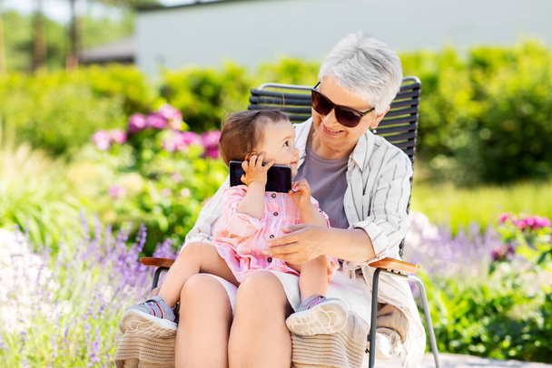 grandmother and baby granddaughter with smartphone - Photo, image