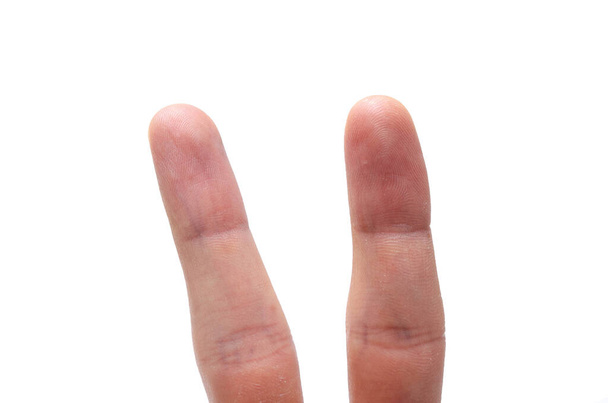 Two fingers on a white background with and without a face. Various emotions, joy, sadness, anger are depicted on the fingers - Photo, Image