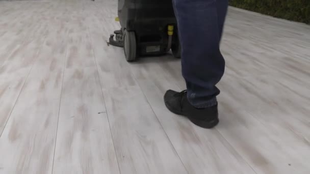 A worker uses a floor cleaning machine. - Footage, Video