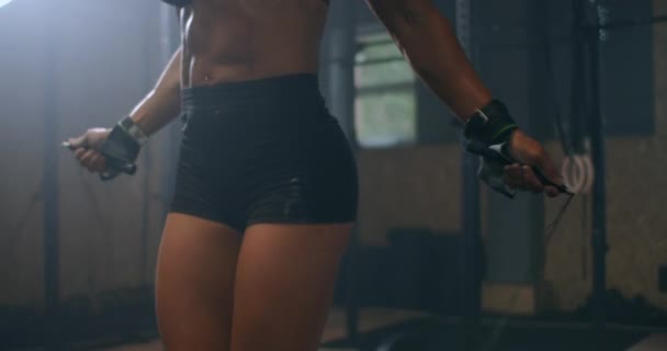 Slow motion: Skipping woman training at the gym. Young woman skipping rope. Athlete female jumping on skipping rope at cardio training in gym club. - Footage, Video