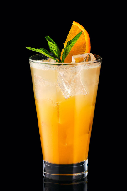 Cold fizz cocktail with orange isolated on black background - Foto, Imagen