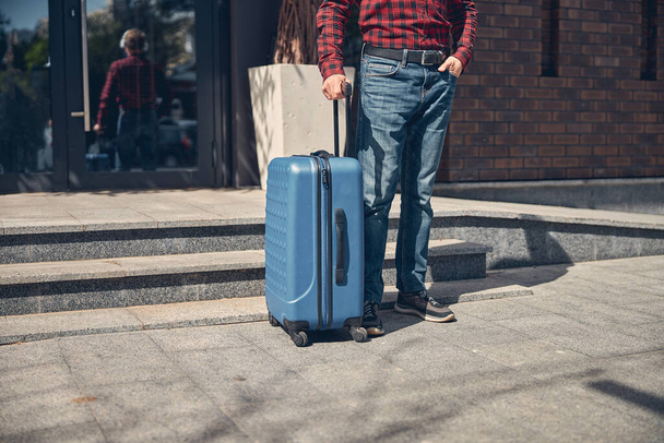 Stylish man with travel suitcase standing on the street - Zdjęcie, obraz