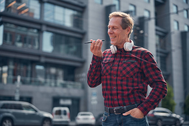 Cheerful man having phone conversation on the street - Φωτογραφία, εικόνα