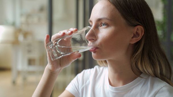 Female drinking from a glass of water. Health care concept photo, lifestyle, close up - Fotografie, Obrázek