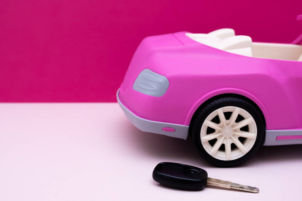 Car keys and pink car mockup. Concept of car sale, car rental. - Photo, Image