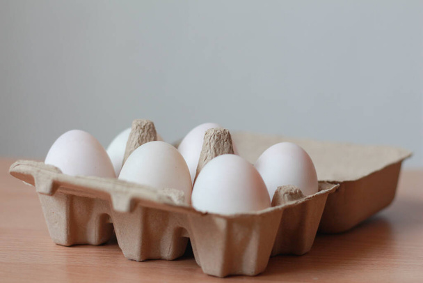 Egg in the box on table. - Foto, Imagen